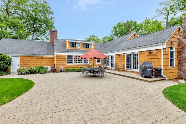 2 The Spout, Smithtown, NY 11787 - rear view of house featuring a chimney, a patio area, and a shingled roof