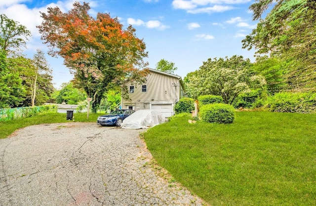 481 E Branch Rd, Patterson, NY 12563 - view of side of property with driveway, an attached garage, and a lawn