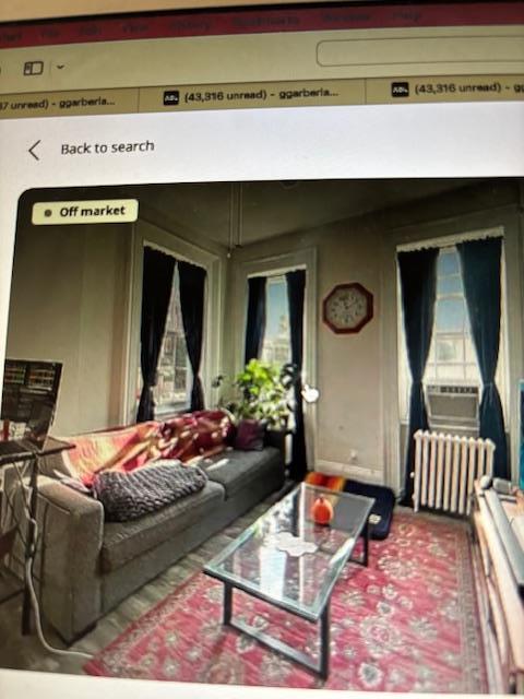135 Saint Marks Ave, Brooklyn, NY 11217 - living area with radiator heating unit, plenty of natural light, and cooling unit