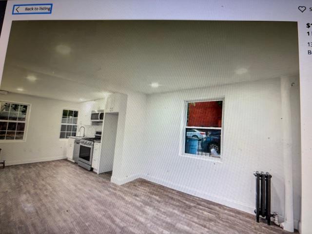 135 Saint Marks Ave, Brooklyn, NY 11217 - unfurnished living room with baseboards and wood finished floors