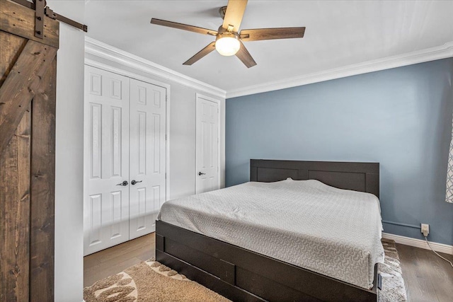 99-40 63rd Rd Unit 1Z, Rego Park, NY 11374 - bedroom with crown molding, wood finished floors, ceiling fan, and a barn door