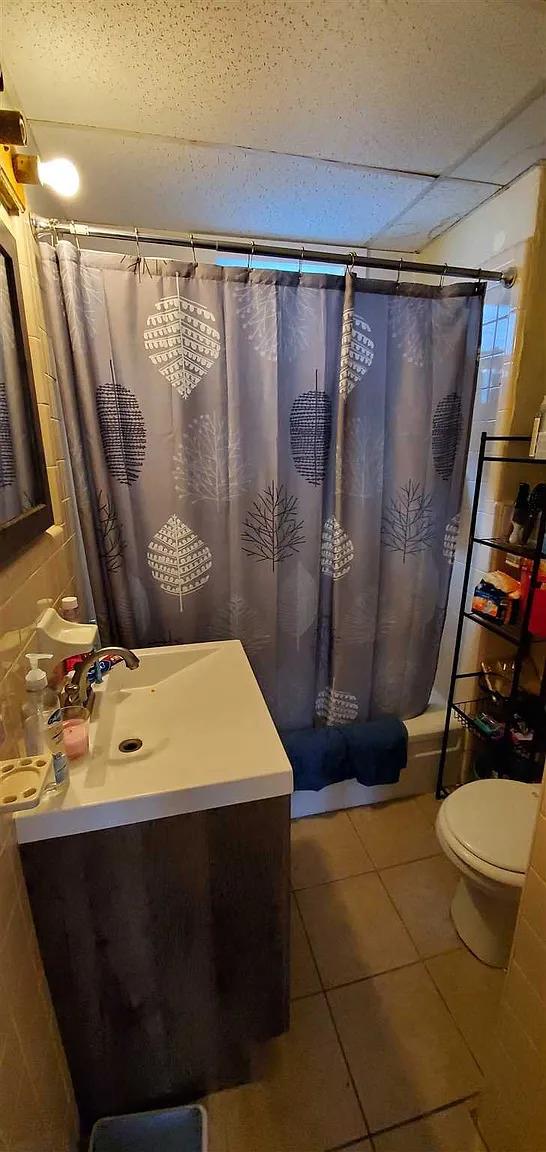 77 Carroll St, Poughkeepsie, NY 12601 - full bathroom featuring vanity, tile patterned floors, and shower / bath combo