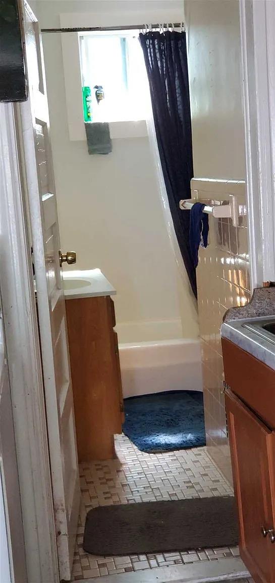 77 Carroll St, Poughkeepsie, NY 12601 - bathroom featuring vanity, shower / bath combo, and tile patterned floors