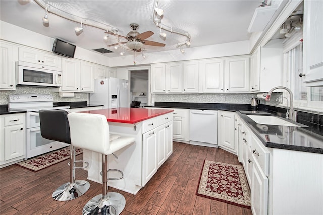25 Fountain Dr, Valhalla, NY 10595 - kitchen featuring white appliances, dark countertops, and white cabinetry