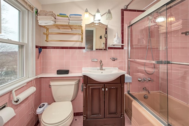 25 Fountain Dr, Valhalla, NY 10595 - full bathroom with tile walls, vanity, enclosed tub / shower combo, and a wainscoted wall