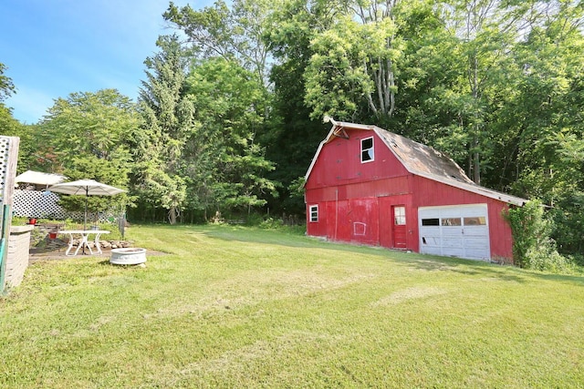 38 Wilson St, Middletown, NY 10940 - view of grassy yard featuring a barn, a garage, an outbuilding, and driveway