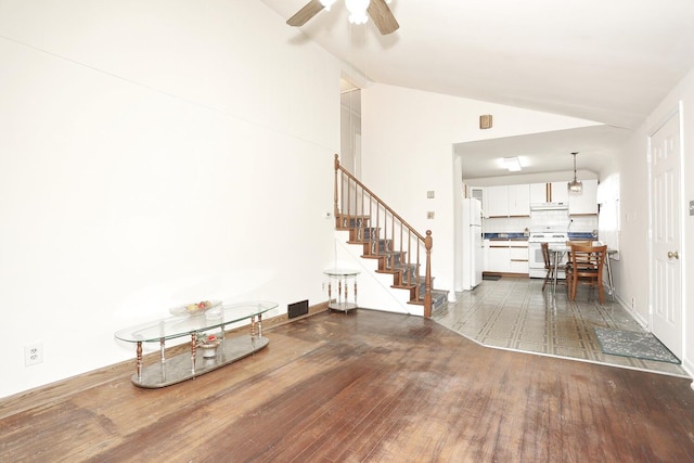 38 Wilson St, Middletown, NY 10940 - living area with stairway, dark wood finished floors, ceiling fan, and high vaulted ceiling