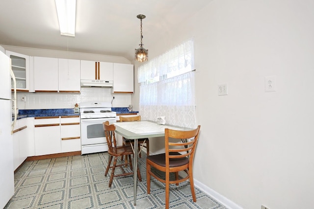 38 Wilson St, Middletown, NY 10940 - kitchen featuring white appliances, under cabinet range hood, backsplash, white cabinetry, and pendant lighting