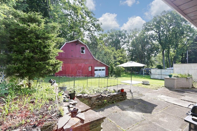 38 Wilson St, Middletown, NY 10940 - view of patio / terrace featuring a barn, a detached garage, and an outbuilding