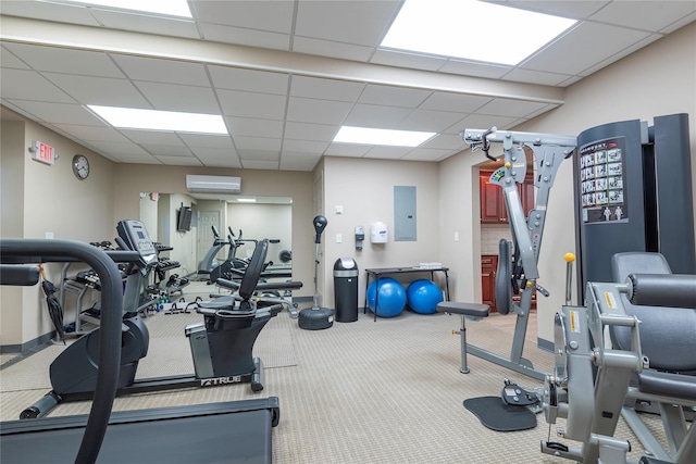 25 Chapel Pl Unit 3N, Great Neck, NY 11021 - gym featuring electric panel, a paneled ceiling, an AC wall unit, carpet flooring, and baseboards