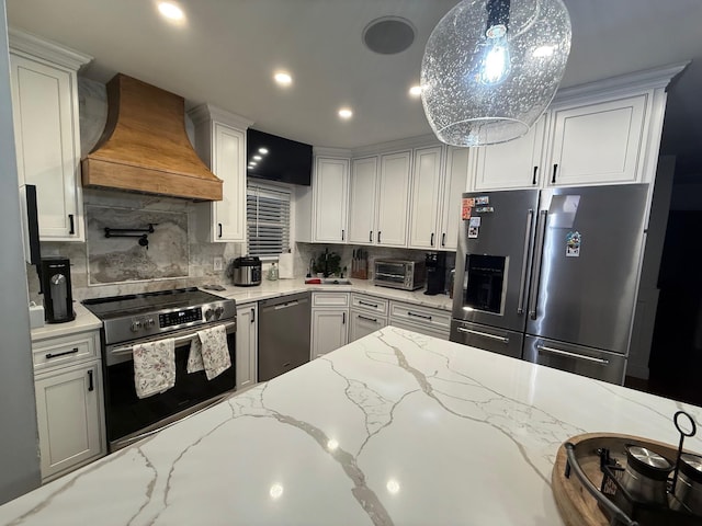 1803 Front St, East Meadow, NY 11554 - kitchen with appliances with stainless steel finishes, premium range hood, tasteful backsplash, light stone countertops, and recessed lighting