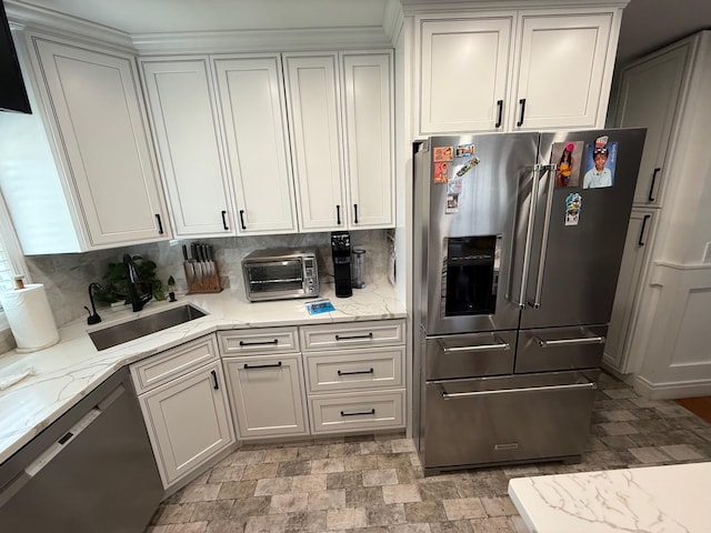 1803 Front St, East Meadow, NY 11554 - kitchen with appliances with stainless steel finishes, light stone counters, and backsplash