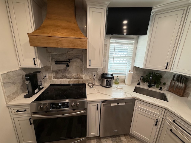 1803 Front St, East Meadow, NY 11554 - kitchen featuring appliances with stainless steel finishes, custom exhaust hood, tasteful backsplash, and white cabinets