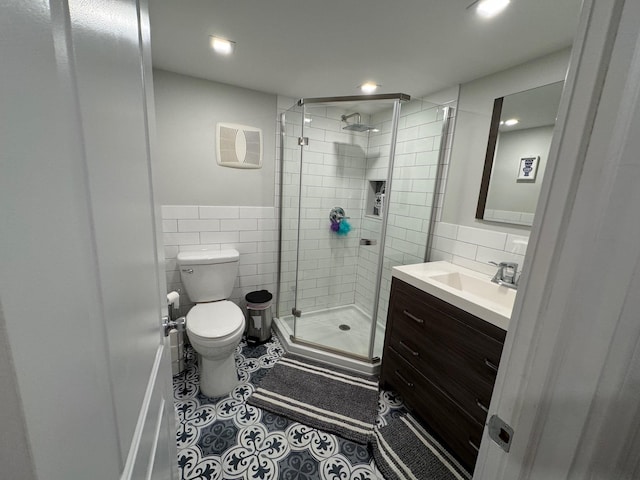 1803 Front St, East Meadow, NY 11554 - full bathroom with tile walls, vanity, a shower stall, tile patterned flooring, and recessed lighting