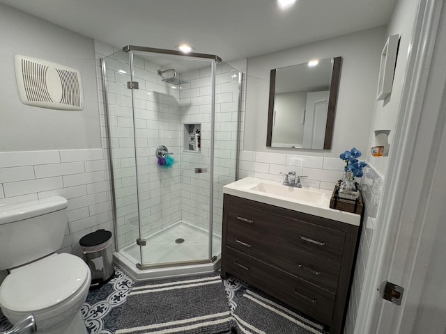 1803 Front St, East Meadow, NY 11554 - full bathroom featuring tile walls, a stall shower, vanity, a wainscoted wall, and tile patterned floors