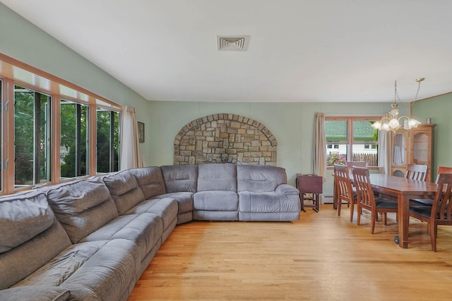 21 Spectacle Lake Dr, Smithtown, NY 11767 - living room featuring a chandelier and light wood-style floors