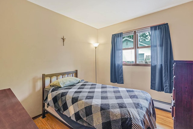 21 Spectacle Lake Dr, Smithtown, NY 11767 - bedroom featuring wood finished floors and baseboard heating