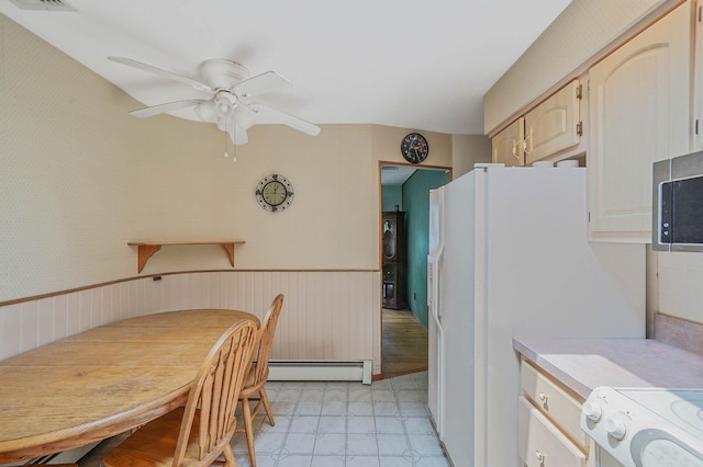 21 Spectacle Lake Dr, Smithtown, NY 11767 - kitchen featuring a baseboard radiator, ceiling fan, range, stainless steel microwave, and light flooring