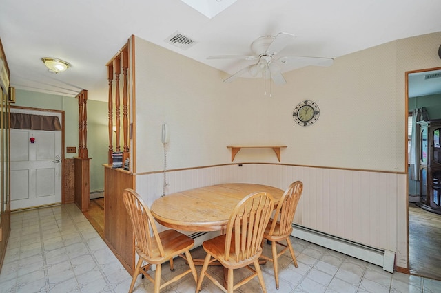 21 Spectacle Lake Dr, Smithtown, NY 11767 - dining room with a baseboard radiator, light floors, a wainscoted wall, and a ceiling fan