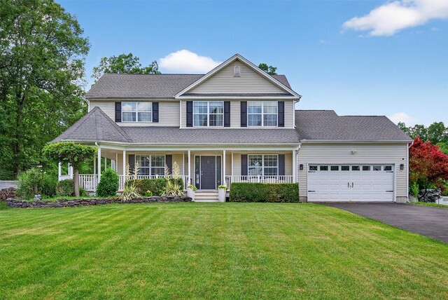 11 Pacer Ct, Goshen, NY 10924 - view of front of home with asphalt driveway, an attached garage, a porch, and a front lawn