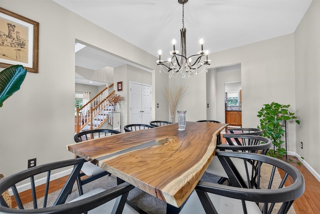 11 Pacer Ct, Goshen, NY 10924 - dining room featuring light wood-type flooring, a chandelier, stairs, and healthy amount of natural light