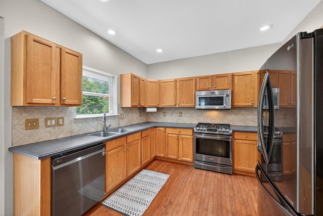 11 Pacer Ct, Goshen, NY 10924 - kitchen featuring stainless steel appliances, light wood-type flooring, dark countertops, recessed lighting, and tasteful backsplash