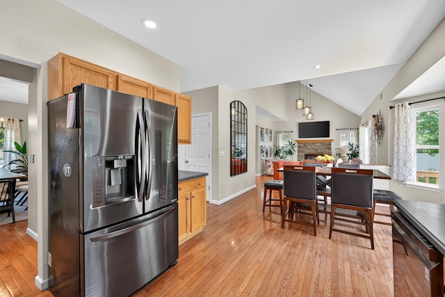 11 Pacer Ct, Goshen, NY 10924 - kitchen with stainless steel refrigerator with ice dispenser, dishwasher, light wood finished floors, dark countertops, and lofted ceiling