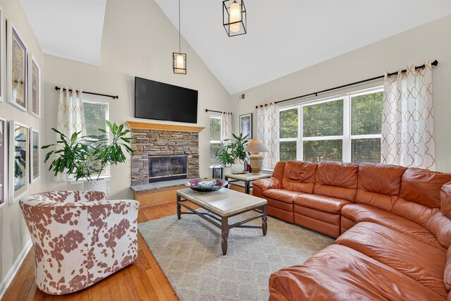 11 Pacer Ct, Goshen, NY 10924 - living area featuring high vaulted ceiling, wood finished floors, plenty of natural light, and a stone fireplace