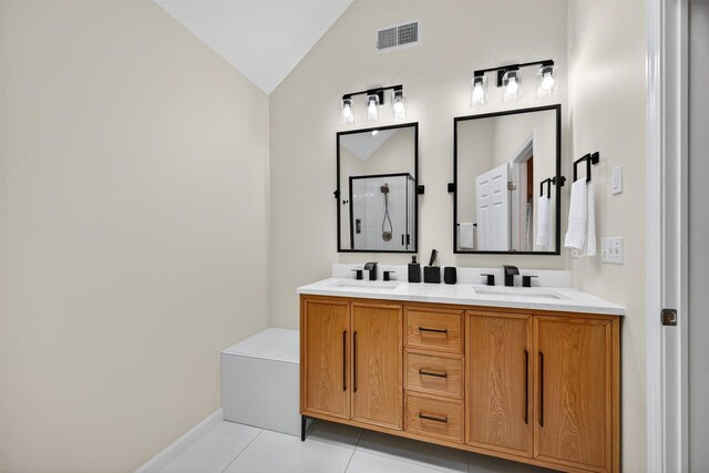 11 Pacer Ct, Goshen, NY 10924 - bathroom featuring lofted ceiling, tile patterned flooring, double vanity, and a shower