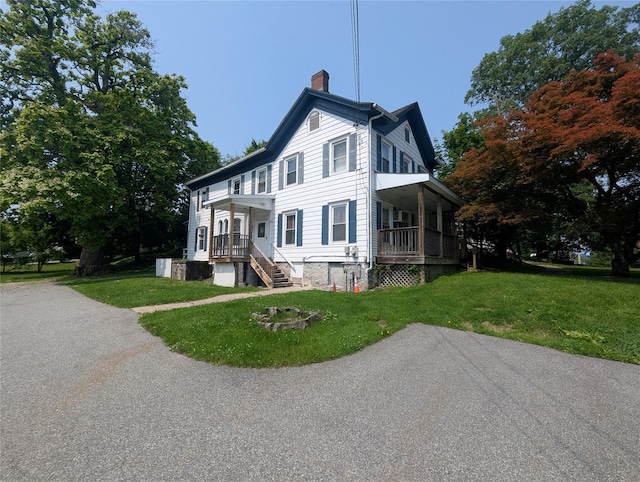 265 Goodwill Rd, Montgomery, NY 12549 - view of side of home with a chimney, a lawn, and covered porch