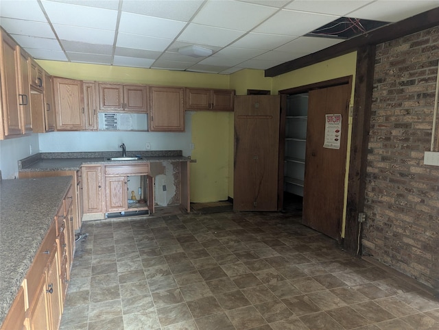 265 Goodwill Rd, Montgomery, NY 12549 - kitchen featuring a paneled ceiling, brick wall, and stone finish floors