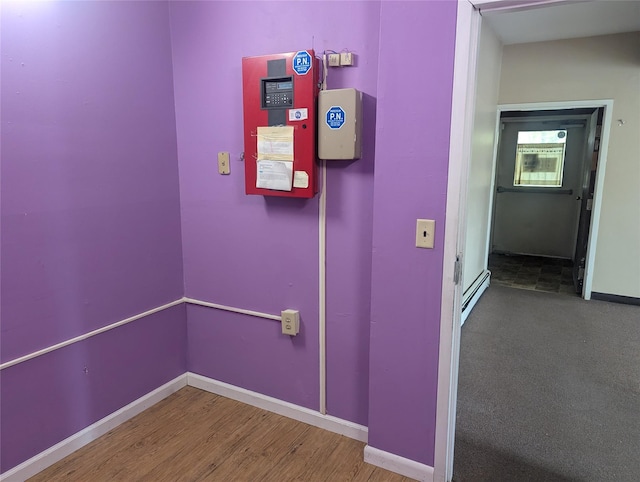265 Goodwill Rd, Montgomery, NY 12549 - corridor featuring wood finished floors and a baseboard heating unit