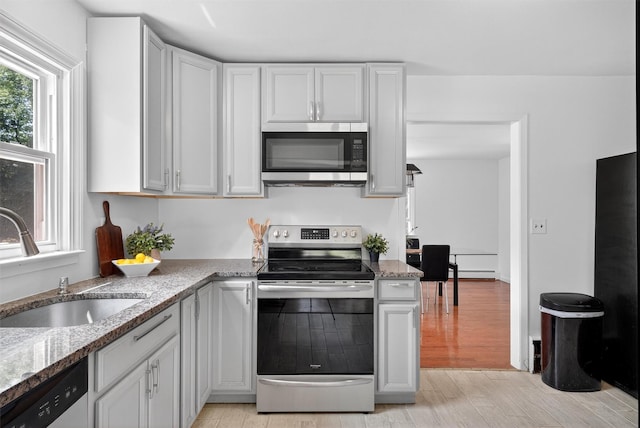 26 Helena Ave, Mohegan Lake, NY 10547 - kitchen featuring stainless steel appliances, light wood-style floors, light stone countertops, and white cabinets