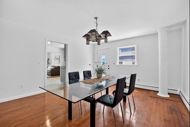 26 Helena Ave, Mohegan Lake, NY 10547 - dining space with a chandelier, wood finished floors, and ornate columns