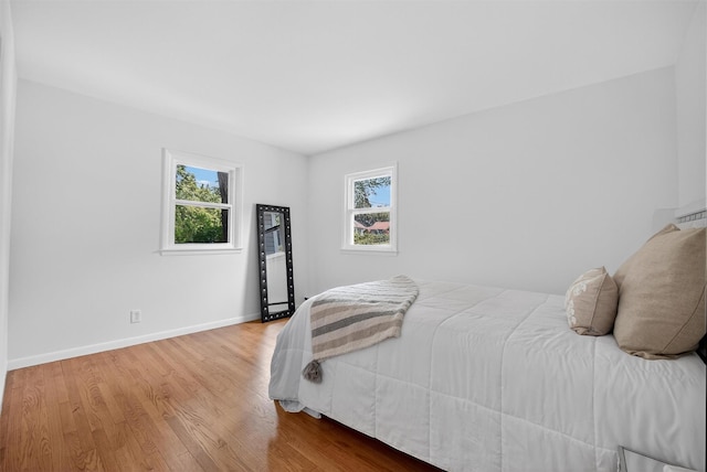 26 Helena Ave, Mohegan Lake, NY 10547 - bedroom featuring multiple windows and wood finished floors