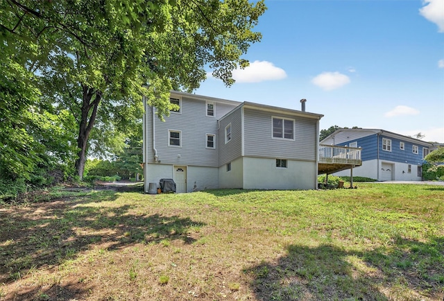 26 Helena Ave, Mohegan Lake, NY 10547 - rear view of property featuring a lawn, a deck, and an attached garage