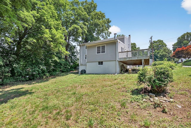 26 Helena Ave, Mohegan Lake, NY 10547 - rear view of house with a wooden deck, a yard, and a chimney