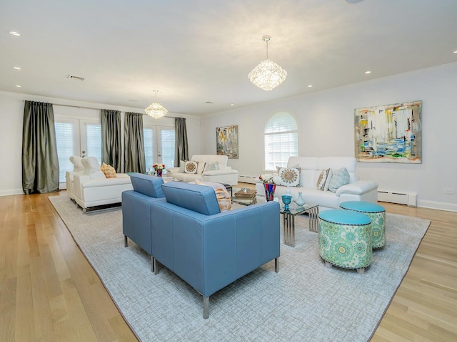 70 Scudders Ln, Roslyn Harbor, NY 11576 - living room with a chandelier, a baseboard heating unit, light wood-style flooring, recessed lighting, and crown molding