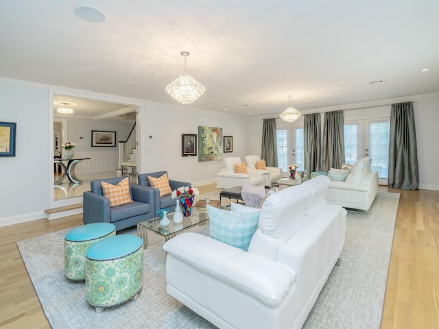 70 Scudders Ln, Roslyn Harbor, NY 11576 - living room featuring a chandelier, stairs, light wood finished floors, and ornamental molding