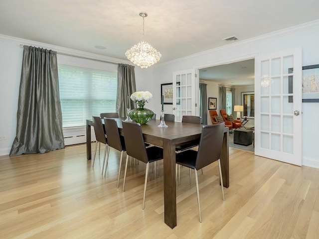 70 Scudders Ln, Roslyn Harbor, NY 11576 - dining area with a chandelier, crown molding, light wood-style flooring, french doors, and a baseboard heating unit