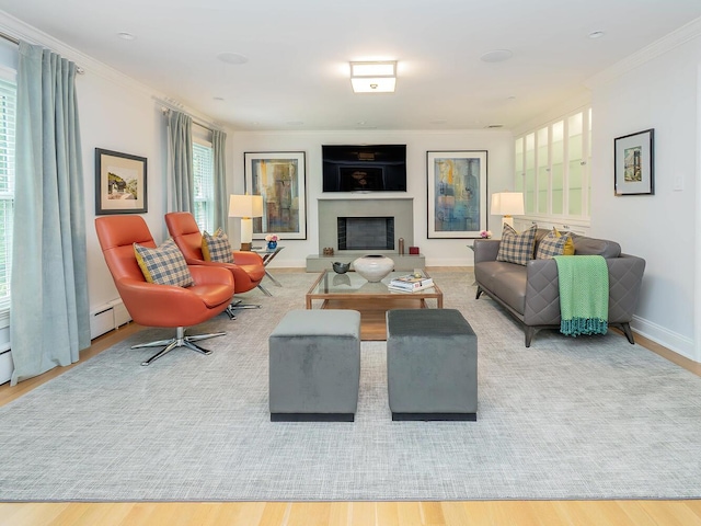 70 Scudders Ln, Roslyn Harbor, NY 11576 - living area featuring ornamental molding, a fireplace with raised hearth, and wood finished floors