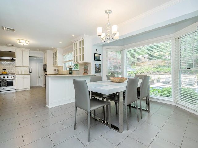 70 Scudders Ln, Roslyn Harbor, NY 11576 - dining space featuring crown molding, a chandelier, healthy amount of natural light, light tile patterned floors, and recessed lighting