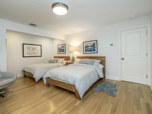 70 Scudders Ln, Roslyn Harbor, NY 11576 - bedroom with light wood-style floors and baseboards
