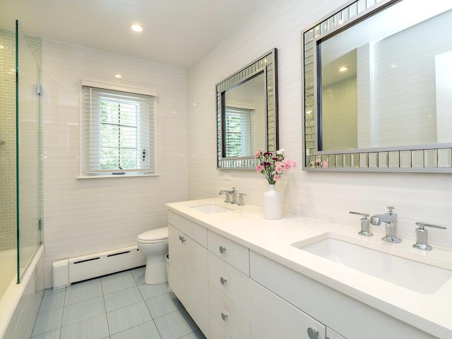 70 Scudders Ln, Roslyn Harbor, NY 11576 - bathroom featuring a baseboard heating unit, tile patterned flooring, tile walls, double vanity, and bath / shower combo with glass door