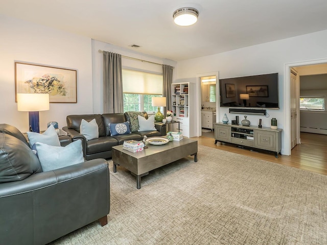 70 Scudders Ln, Roslyn Harbor, NY 11576 - living area with baseboard heating and light wood-style floors