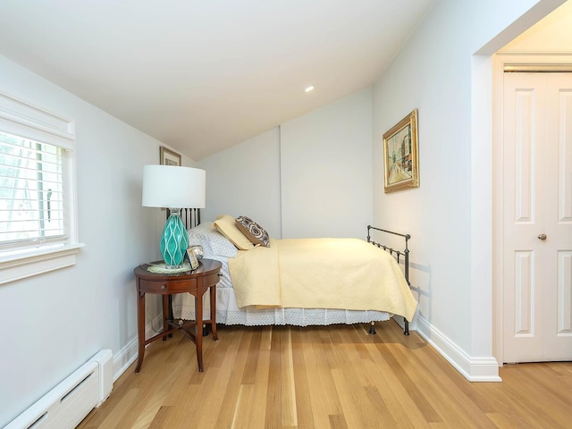 70 Scudders Ln, Roslyn Harbor, NY 11576 - bedroom with a baseboard radiator, light wood finished floors, and lofted ceiling