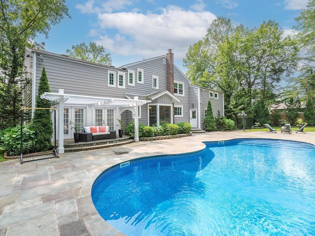 70 Scudders Ln, Roslyn Harbor, NY 11576 - swimming pool featuring a pergola, an outdoor hangout area, french doors, and a patio area