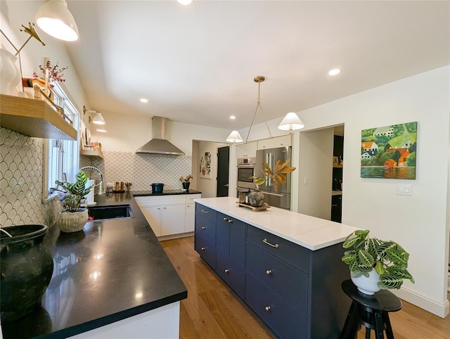 1 Concord Dr, Fort Salonga, NY 11768 - kitchen with wall chimney range hood, freestanding refrigerator, tasteful backsplash, white cabinetry, and light wood finished floors