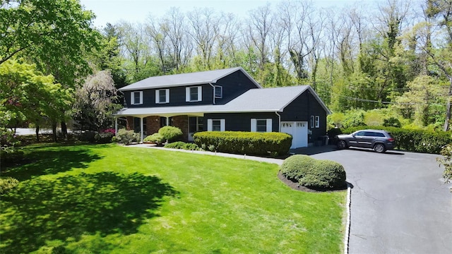 1 Concord Dr, Fort Salonga, NY 11768 - traditional-style home featuring a garage, a front lawn, and asphalt driveway