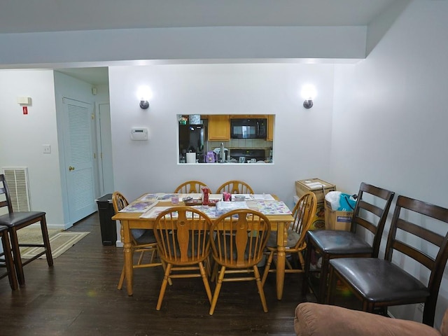147 Ruth Ct, Middletown, NY 10940 - dining room with dark wood-style floors and baseboards